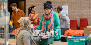 a group volunteers organising food donations